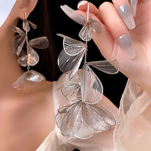 Elegant hollow floral silver metal drop earrings showing a sophisticated layered design