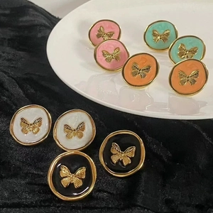 French vintage enamel butterfly stud earrings in five colors on ceramic display