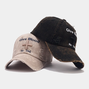 Close-up of vintage washed baseball caps with embroidered cross and distressed details