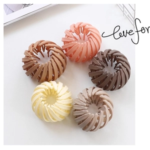 Detailed view of five matte bird nest hair clips in Morandi colors for buns and ponytails