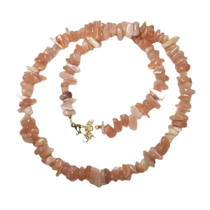 Natural orange moonstone crushed stone necklace with gold lobster clasp on white background