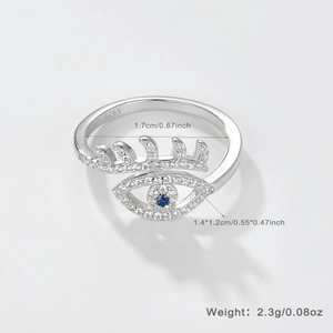 Macro detail of S925 sterling silver evil eye ring with blue stone and white crystals