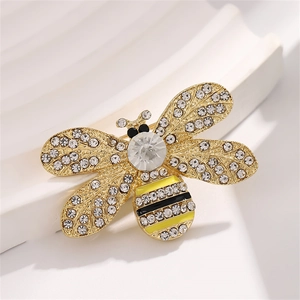 Golden bee brooch with clear crystals and black yellow enamel on white background