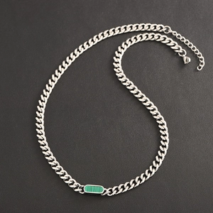 Silver Cuban chain necklace with a green striped rectangular pendant on black background
