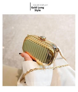 Detailed view of long gold metallic evening clutch bag with elegant pleated texture and chain