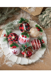 Close-up of assorted plaid and burlap Christmas balls with pine cones and red berries