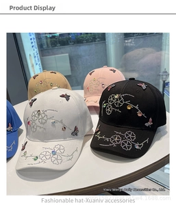 Detail of baseball caps with rhinestones showing colorful floral and butterfly patterns