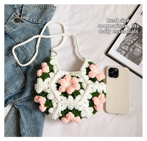 Detailed size comparison of handmade crochet 3D puff flower crossbody bag with a smartphone