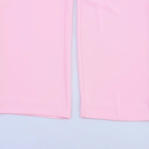 Detail of pink blazer side slit and professional hem stitching on plain weave fabric