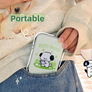 Macro detail of cartoon dog tin storage box being tucked into a blue jeans pocket