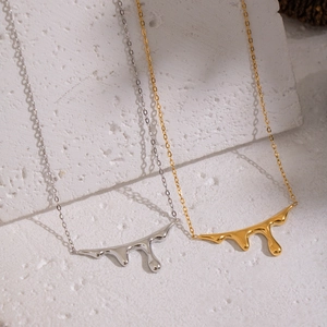 Minimalist fluid lava pendant necklace in gold and silver finish on white stone