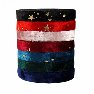 Stack of colorful velvet ribbons with gold star patterns for DIY hair accessories