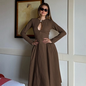 Detail of a dark brown long-sleeve dress with chest hollow-out and linen texture