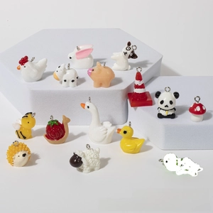 Detailed view of assorted acrylic animal charms with metal loops for DIY jewelry projects