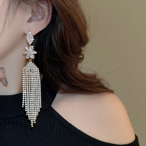 Close-up of model wearing silver flower tassel earrings with sparkling zircon crystals