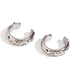 Polished silver C-shaped ear cuffs with sparkling cubic zirconia on white background