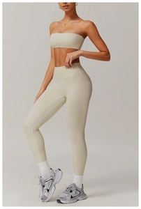 Detail of high-waisted yoga leggings and sports bra set in beige stretch fabric