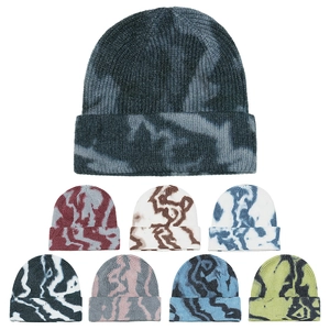Flat lay of tie-dye knitted beanies showing eight distinct color variants and thick ribbing