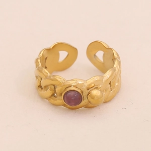 Detailed shot of vintage gold chain ring featuring a purple stone and golden bead
