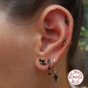 S925 sterling silver gold hoop earrings with black zircon stones shown on a model