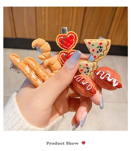 Handheld detail of funny 3D resin food hair clips featuring pizza and hot dog designs
