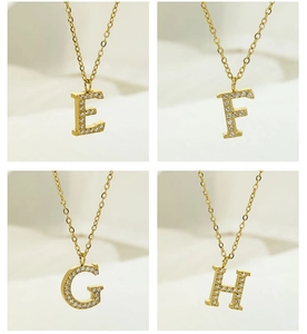Detail showing gold plated initial pendants E F G H with white zircon stones on chains