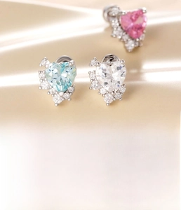 Macro shot of titanium steel heart studs with micro-set zircons on champagne satin