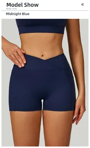 Detail of high-waisted yoga shorts in midnight blue with V-cross waistband and pockets