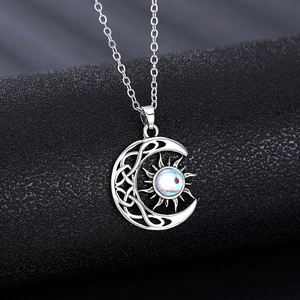 Celestial sun and moon pendant necklace with blue moonstone in Celtic knot design