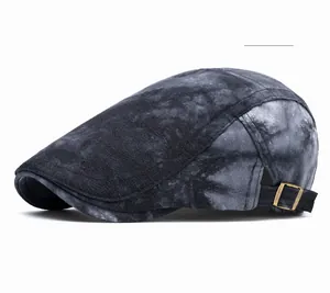 Detail of vintage black newsboy cap featuring distressed texture and bronze metal buckle