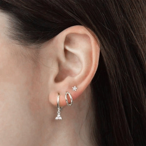 Close-up of S925 silver double hoop earrings and star stud with clear zircon on ear