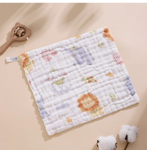 Detail of soft cotton baby gauze towel featuring animal prints and natural texture