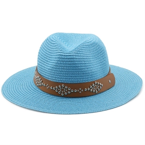 Top view of blue straw beach hat with brown leather rivet band and woven texture