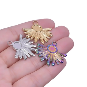 Three sun-shaped 18k plated stainless steel pendants in gold, silver and rainbow colors