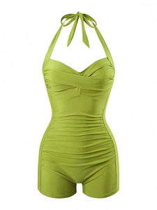 Detail view of grass green one-piece swimsuit with halter neck and slimming ruched fabric