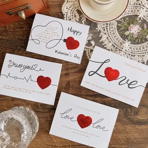 Set of four 3D pop-up heart greeting cards with romantic quotes on wooden background