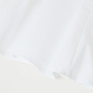 Elegant white cotton A-line dress with detailed hem stitching and natural fabric texture