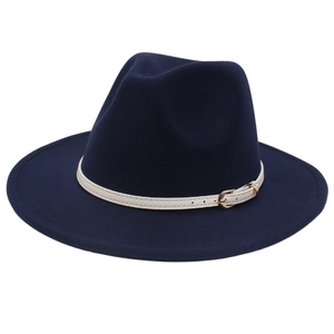 Close-up of deep blue wool fedora hat with cream white leather belt and gold buckle