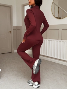 Rear view of wine red Y2K athletic set featuring zip-up top and flared yoga pants