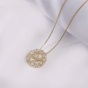 Iced out gold hip hop necklace with round cross pendant and zircon inlay on white background