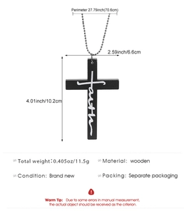 Detailed view of large black wooden cross pendant with white faith text and ball chain