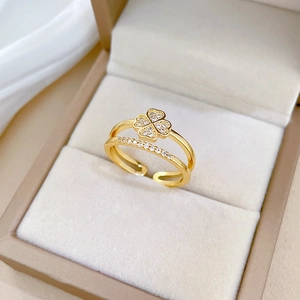 Detailed macro of gold four-leaf clover ring with micro-pave crystals in a jewelry box
