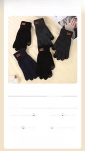 Detail of touchscreen conductive fingertips and brown leather label on knit gloves