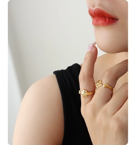 Detailed view of an adjustable gold fox-shaped ring worn on a finger for fashion display