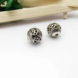 Two Tibetan silver hollow round beads with intricate floral engraving for jewelry making