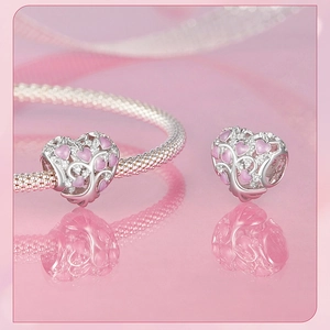 Macro shot of S925 sterling silver heart charm with pink enamel and cubic zirconia detail