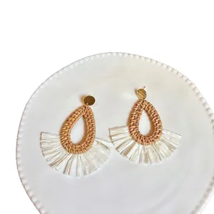Bohemian teardrop raffia earrings with natural woven texture and gold metal studs
