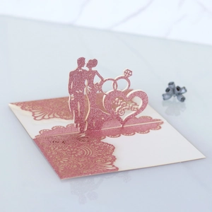 Detail of laser cut 3D wedding invitation with Mr & Mrs silhouette and glitter accents