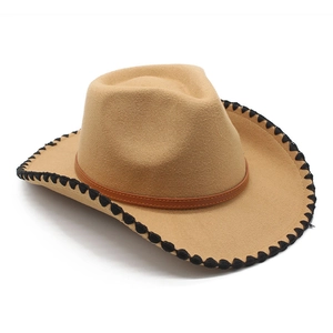 Detail of camel western cowboy hat with black decorative stitching and leather band