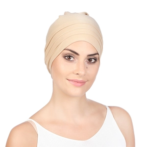 Macro detail of pleated headscarf for women showing texture and light beige fabric finish